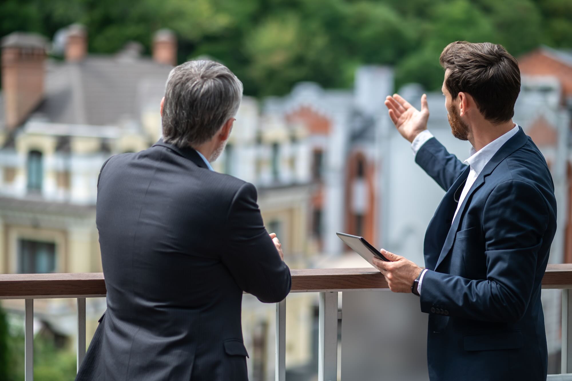Two businessmen looking at a residential complex 