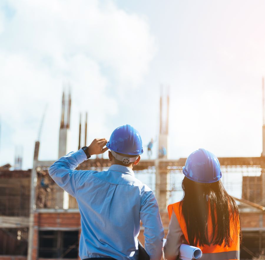 Business man with a female engineer at a construction site