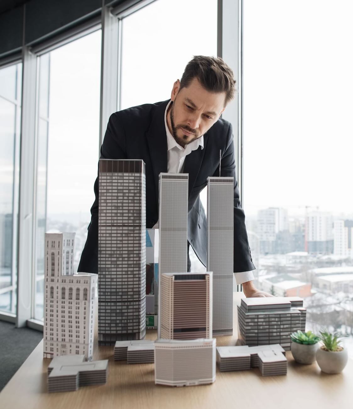 Businessman looking at a 3d model of a construction project