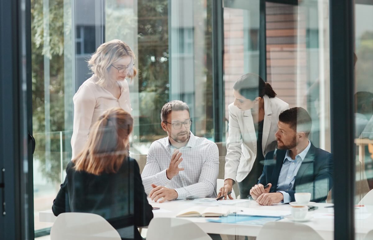 Business meeting shot through a glass wall 
